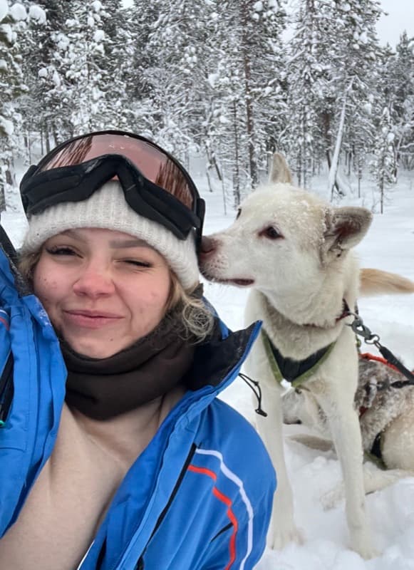Evelyne with a husky in Finnish Lapland