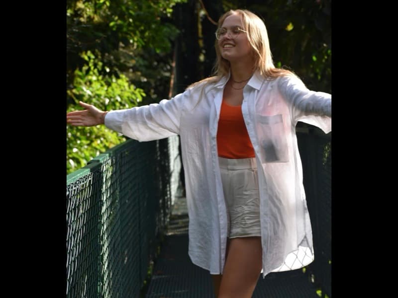 Evelyne on a tropical bridge — orange vibes